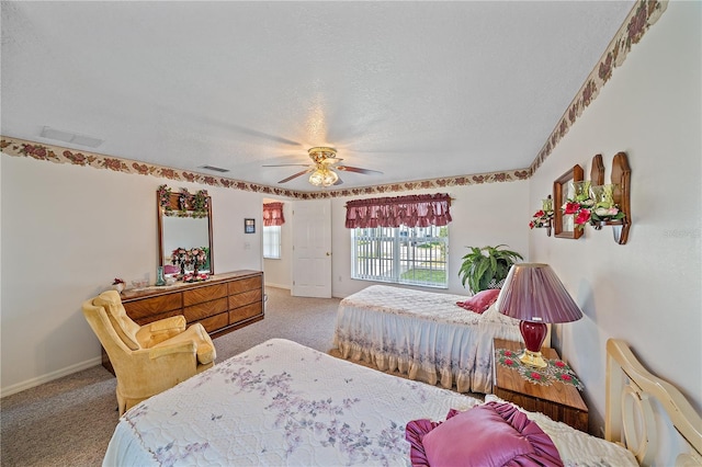 carpeted bedroom with ceiling fan and a textured ceiling