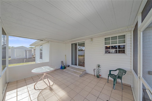 unfurnished sunroom with wood ceiling