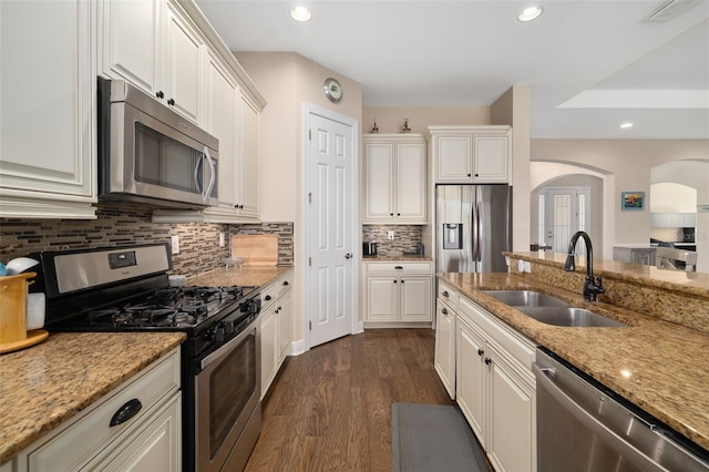 kitchen featuring light stone countertops, sink, white cabinetry, and stainless steel appliances