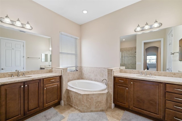 bathroom with tile patterned floors, a healthy amount of sunlight, and independent shower and bath