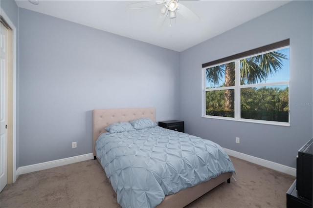 bedroom featuring light colored carpet and ceiling fan