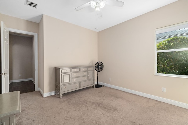 unfurnished bedroom with ceiling fan and light colored carpet