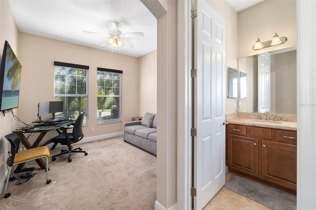 carpeted office featuring ceiling fan and sink