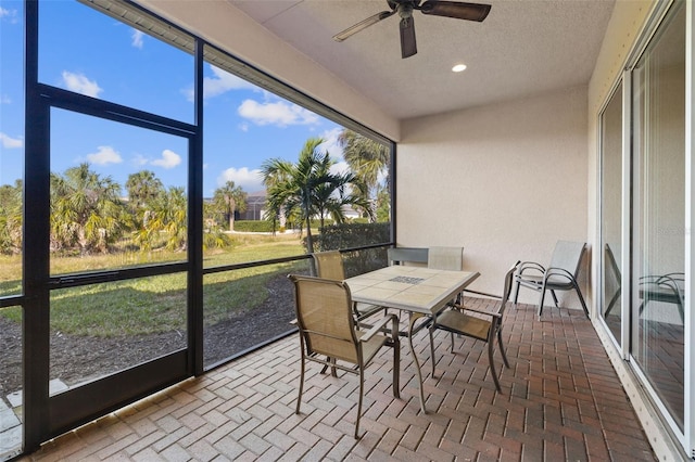 sunroom featuring ceiling fan