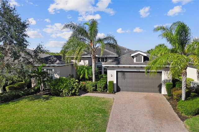 view of front of home with a garage and a front lawn