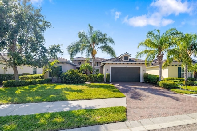 942 Preservation St, Bradenton, FL 34208 - view of front of home with stucco siding, decorative driveway, a garage, a front yard, and a tile roof