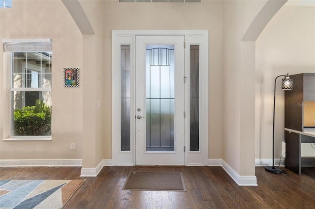 942 Preservation St, Bradenton, FL 34208 - foyer entrance featuring arched walkways, baseboards, and dark wood-style floors
