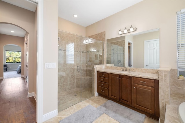 942 Preservation St, Bradenton, FL 34208 - bathroom with a stall shower, ensuite bathroom, vanity, wood finished floors, and recessed lighting