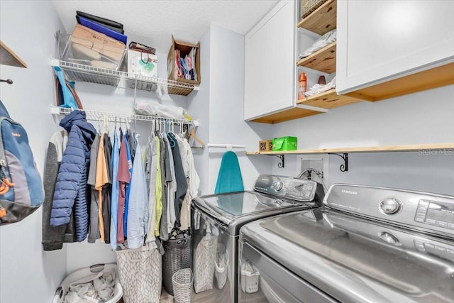 laundry area featuring cabinets and separate washer and dryer