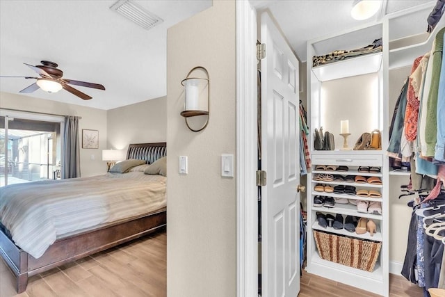 bedroom with light wood-type flooring and ceiling fan