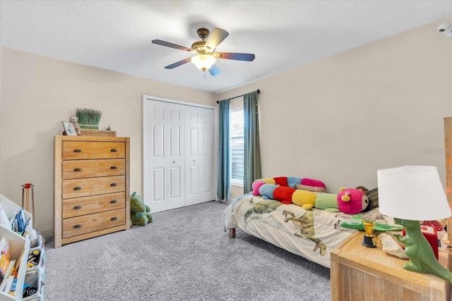 carpeted bedroom with a closet and ceiling fan