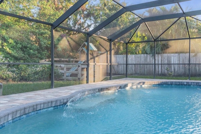 view of pool with a lanai and pool water feature