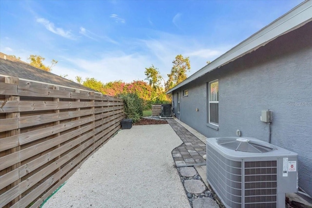 view of home's exterior with cooling unit and a patio area