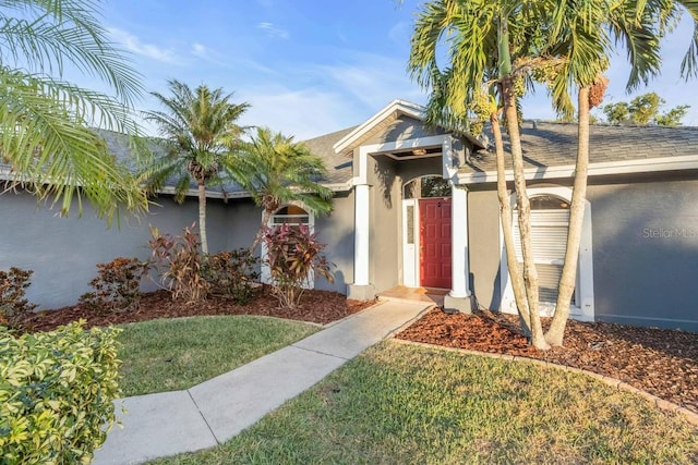 4877 Post Pointe Dr, Sarasota, FL 34233 - single story home with stucco siding, a front lawn, and a shingled roof