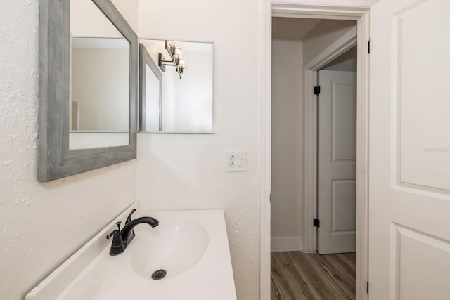 bathroom with vanity and hardwood / wood-style flooring