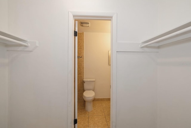 bathroom featuring tile patterned flooring and toilet