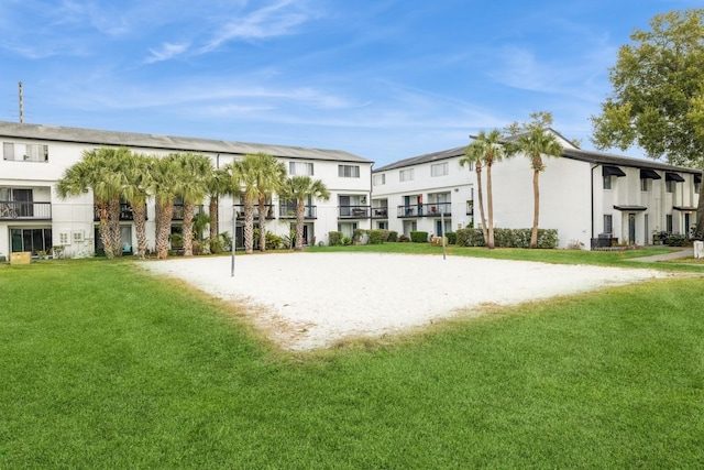 surrounding community featuring a yard and volleyball court