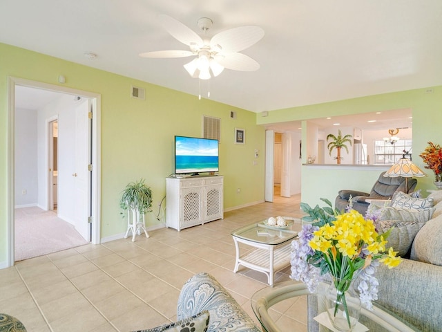 living room with ceiling fan and light tile patterned flooring