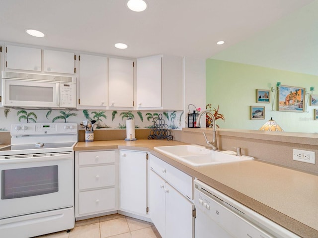 kitchen with white cabinets, white appliances, light tile patterned floors, and sink