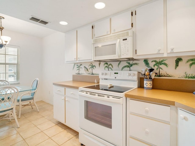 kitchen with a notable chandelier, white appliances, white cabinetry, hanging light fixtures, and light tile patterned flooring