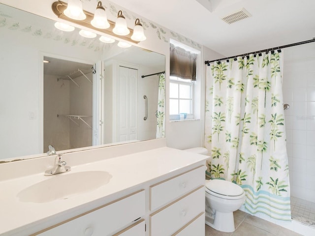 bathroom featuring toilet, vanity, tile patterned floors, and a shower with shower curtain