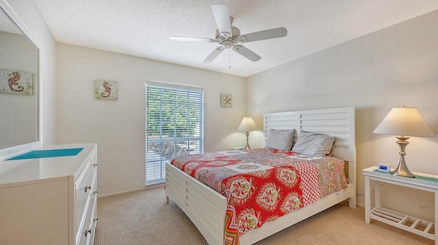 bedroom with light carpet, a textured ceiling, and ceiling fan