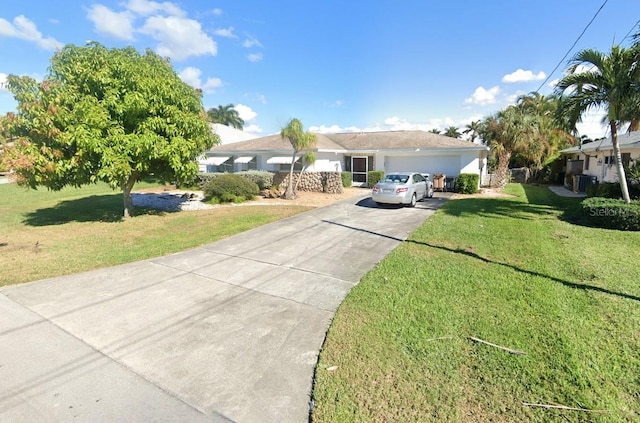 ranch-style home featuring a garage and a front lawn