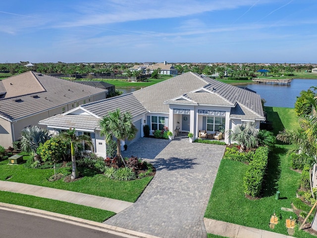 view of front facade with a front lawn and a water view