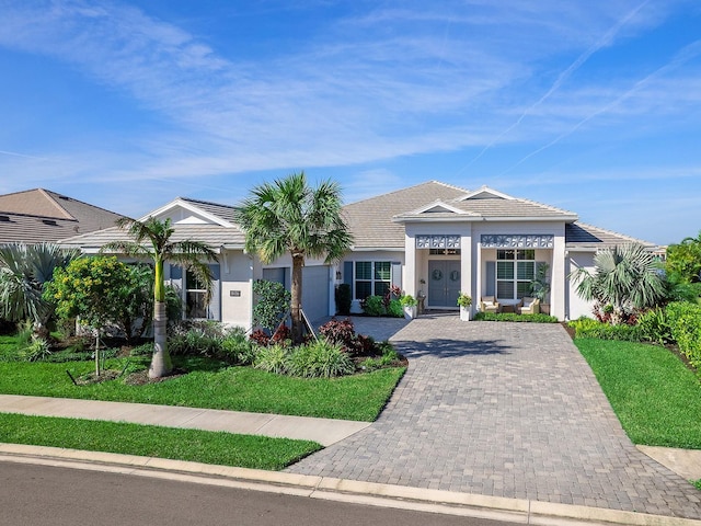 view of front of property with a garage and a front yard