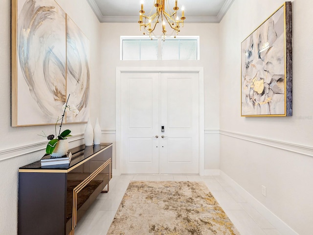 foyer with light tile patterned floors, ornamental molding, and an inviting chandelier