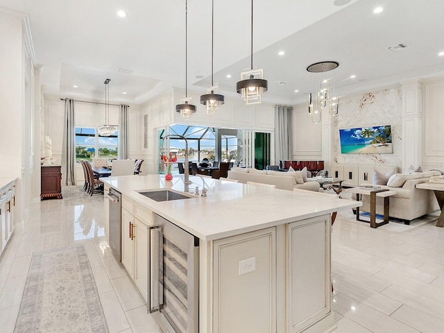 kitchen featuring a breakfast bar, a spacious island, wine cooler, light stone countertops, and decorative light fixtures