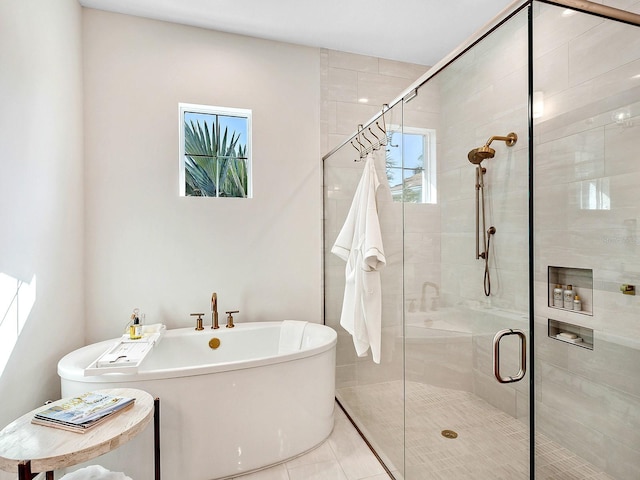 bathroom with tile patterned floors and independent shower and bath