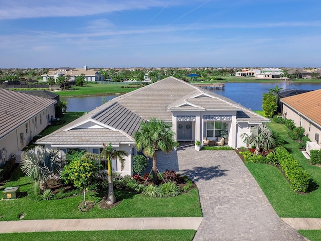 view of front facade with a front yard and a water view