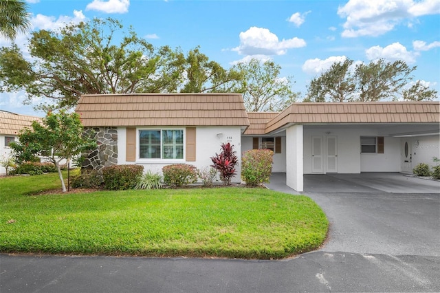 single story home featuring a carport and a front yard