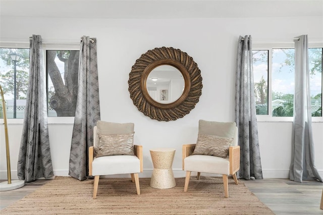 living area with a wealth of natural light and light hardwood / wood-style floors