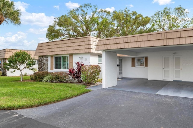 view of front of house featuring a front yard and a carport