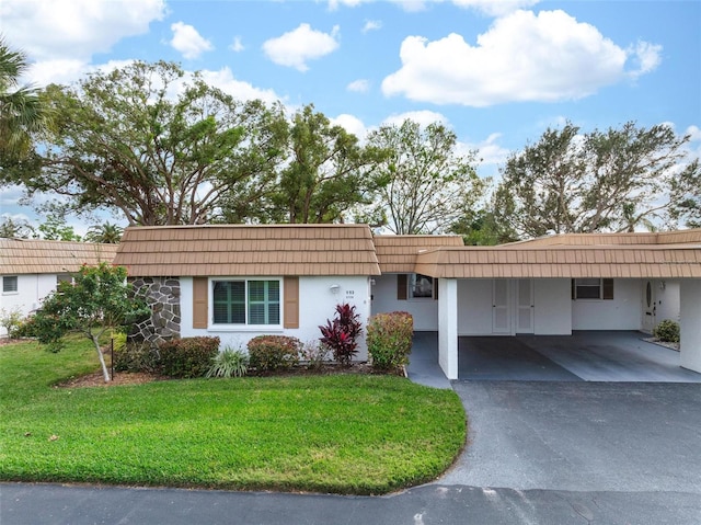 single story home with a carport and a front yard