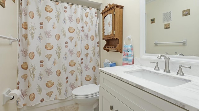 bathroom featuring a shower with curtain, vanity, tile patterned floors, and toilet