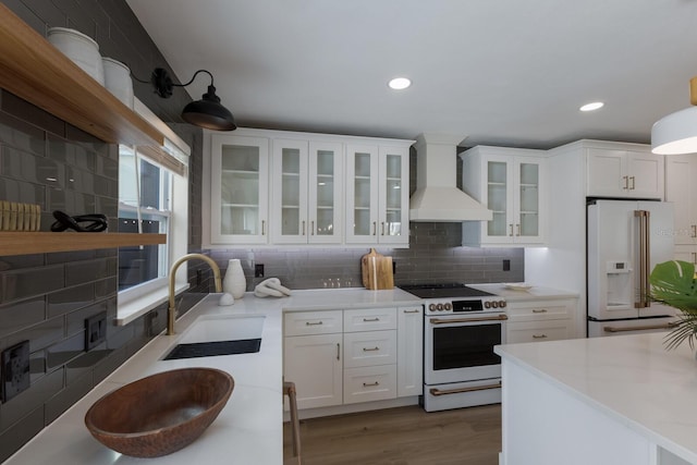 kitchen featuring sink, white appliances, decorative backsplash, white cabinets, and custom exhaust hood