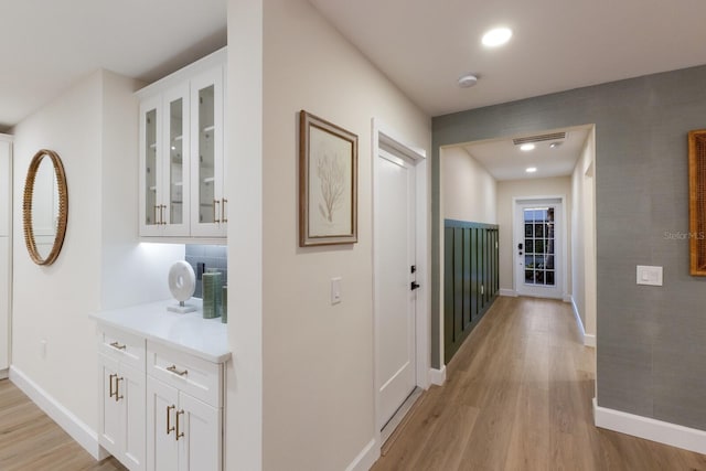 hall with light hardwood / wood-style floors