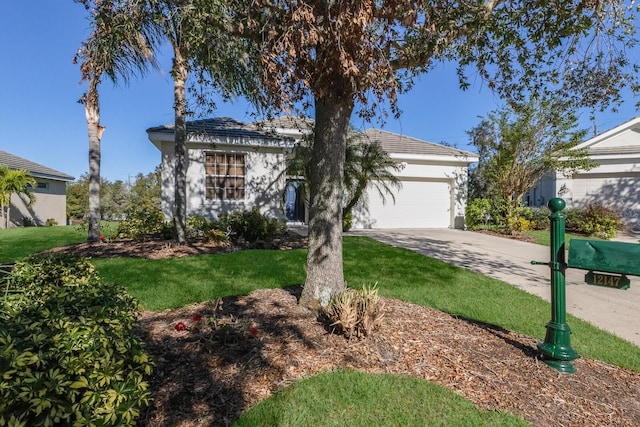 ranch-style house with a garage and a front lawn