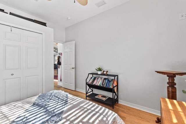 bedroom with wood-type flooring and a closet