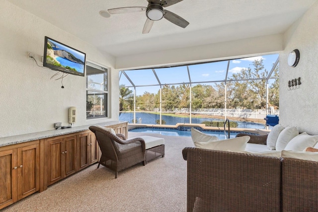 sunroom / solarium featuring ceiling fan and plenty of natural light