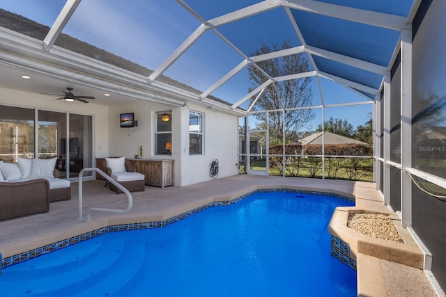 view of pool featuring ceiling fan, a patio, and glass enclosure