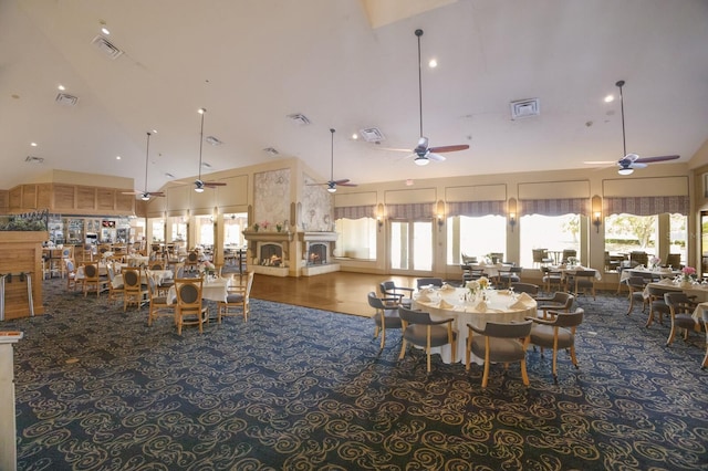 dining space featuring ceiling fan, a healthy amount of sunlight, and high vaulted ceiling