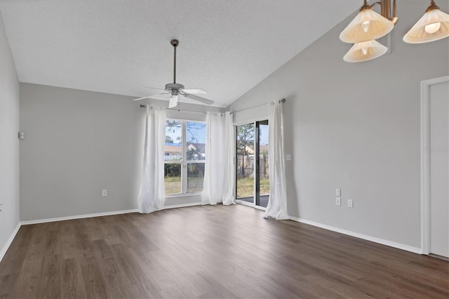 spare room with a textured ceiling, ceiling fan, lofted ceiling, and dark wood-type flooring