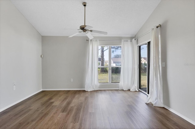 unfurnished room with ceiling fan, dark hardwood / wood-style floors, lofted ceiling, and a textured ceiling