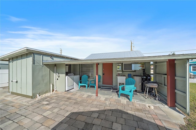 rear view of house with a patio area and independent washer and dryer