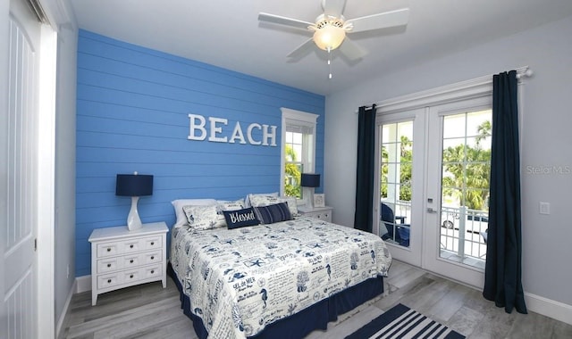 bedroom with access to exterior, light hardwood / wood-style floors, and french doors