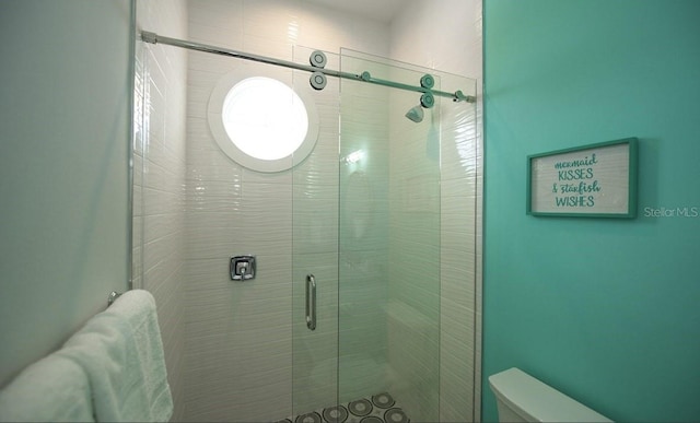 bathroom featuring toilet and walk in shower